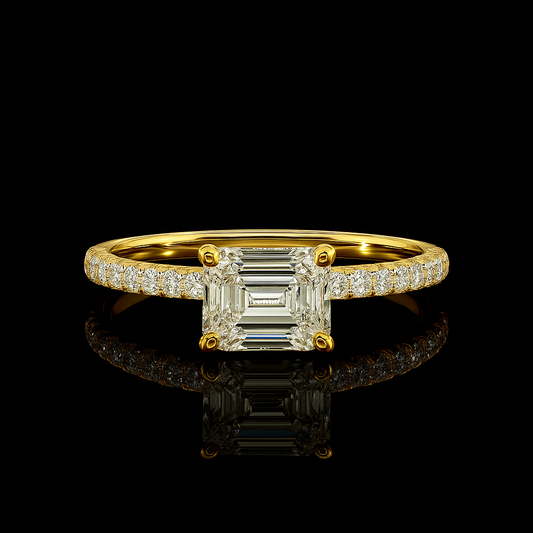Gold ring with a large diamond and smaller diamonds on the band against a black background
