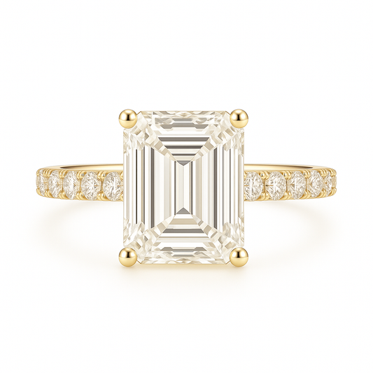 Gold ring with a large emerald-cut diamond and smaller diamonds on the band against a white background