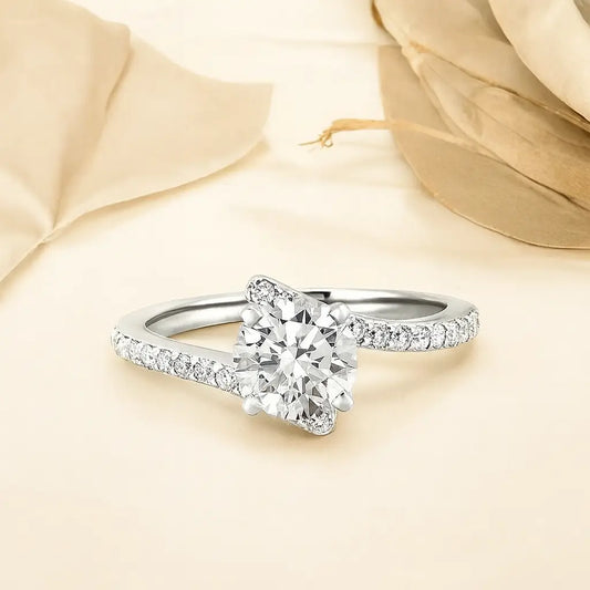 Silver ring with a large diamond and smaller diamonds on the band against a beige fabric background