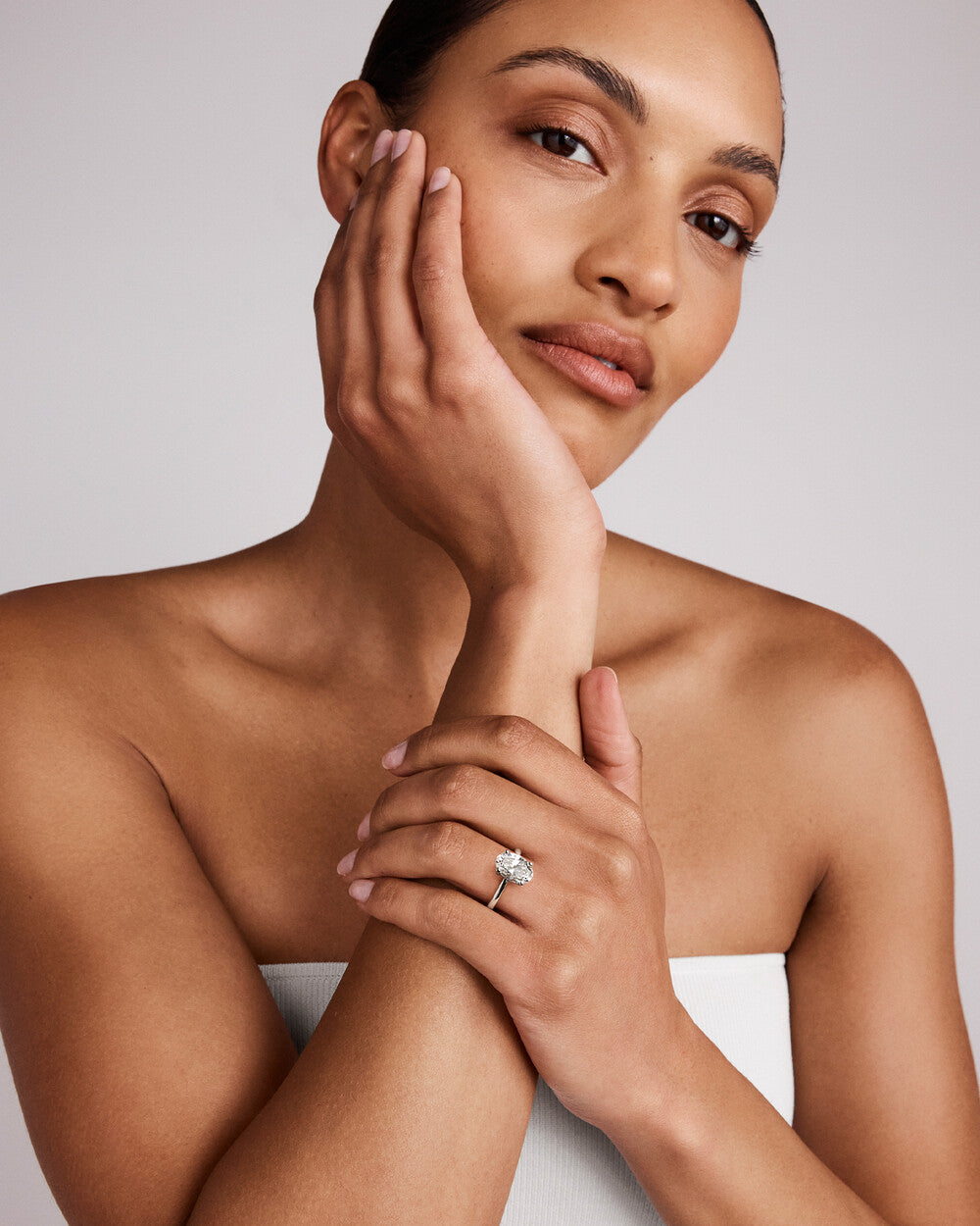 3 carat diamond ring on a white background on hand of a model