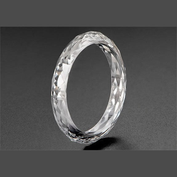 Faceted lab diamond eternity band displayed on a dark background
