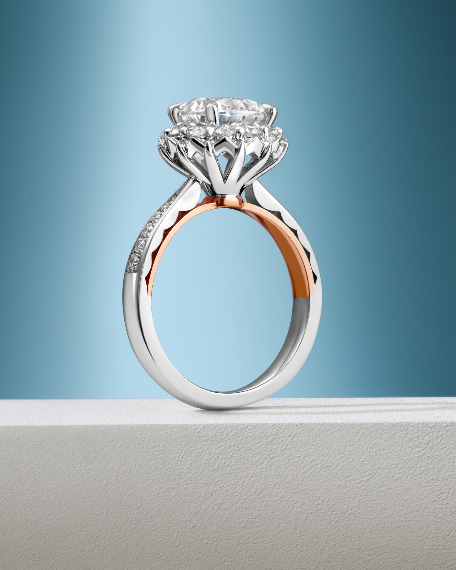 Diamond ring with a two-tone design on a light blue background