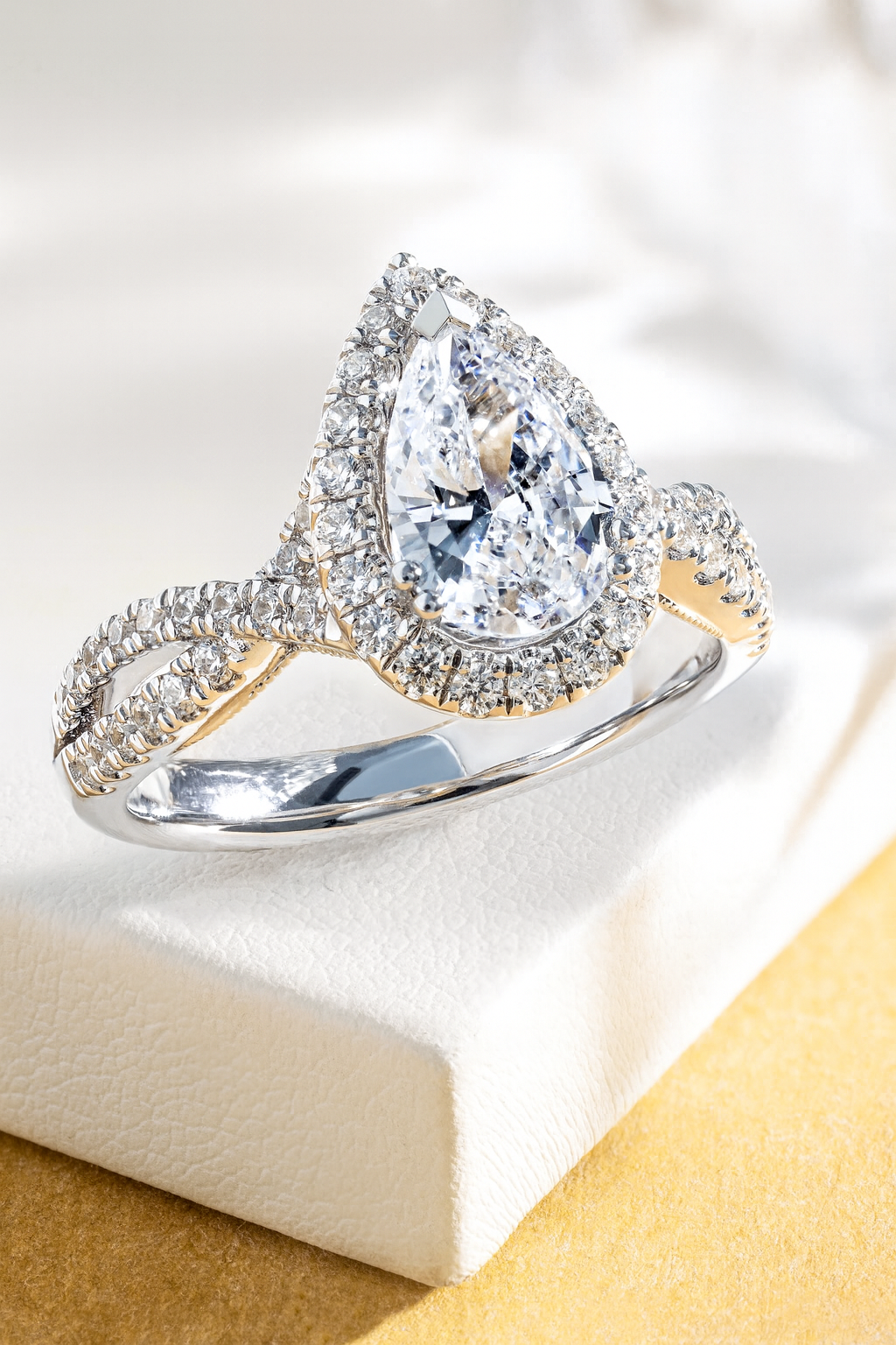 Pear shape lab diamond ring in white gold on a jewelry box