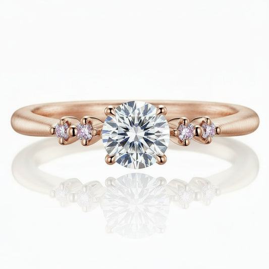 Rose gold ring with a large diamond and smaller diamonds on a white background