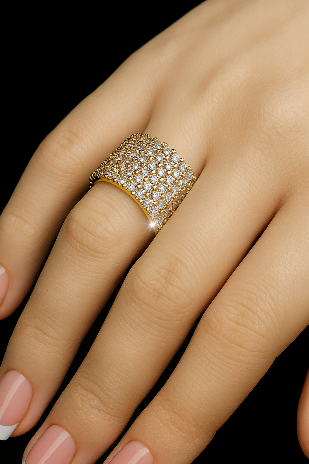 Close up of a woman's hand wearing a white lab diamond eternity band in 14K yellow gold