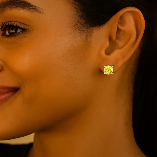 Close-up of a woman wearing a yellow gemstone earring.