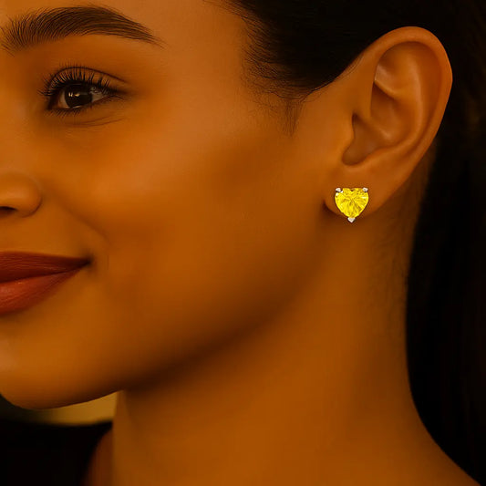 Close-up of a woman wearing a yellow heart-shaped earring.