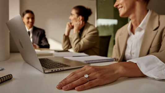 She is wearing her engagement ring at the office 