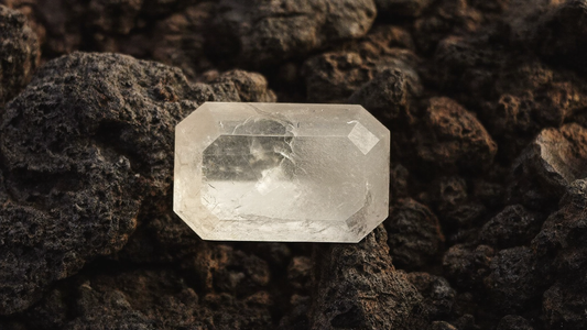 Rough uncut diamond crystal resting on dark kimberlite rock