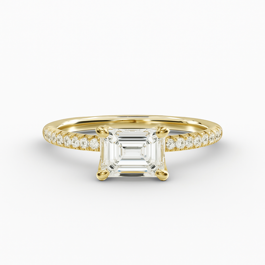 Gold ring with a large diamond and smaller diamonds on the band against a white background