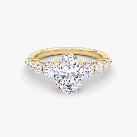 Gold ring with a central diamond and smaller diamonds on a white background
