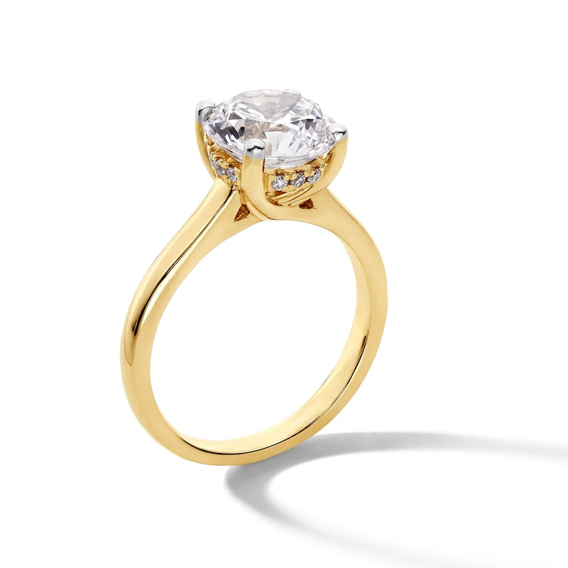 Gold ring with a large diamond on a white background