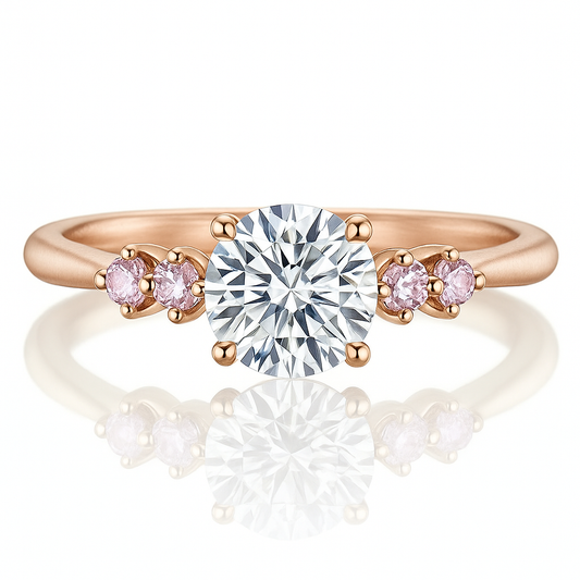 Rose gold ring with a large diamond and smaller pink diamonds on a white background