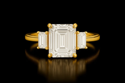 Gold ring with a rectangular diamond on a black background