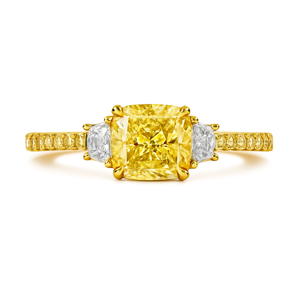 Gold ring with a yellow diamond and two smaller white diamonds on a white background