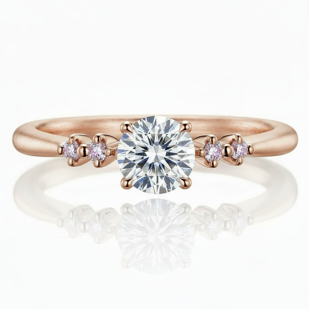 Rose gold ring with a large diamond and smaller diamonds on a white background