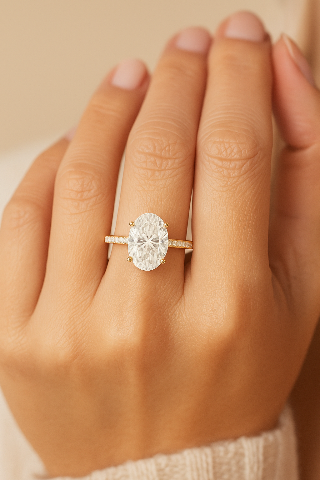 Rose gold ring with a large diamond on a hand against a beige background